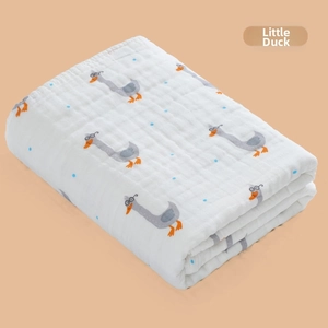 Close-up of soft 6-layer cotton gauze baby blanket with grey duck and blue polka dots