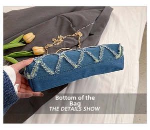 Detail show of denim shell bag rectangle bottom with frayed edges and gold chain strap