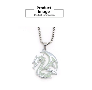 Close-up of retro dragon totem pendant with glowing green insert and silver box chain