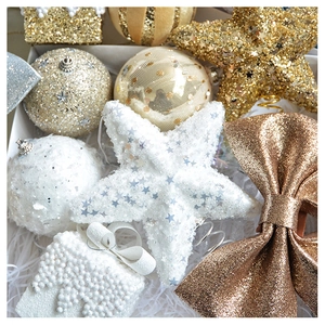 Detailed view of champagne gold Christmas ornaments with glitter bows and beaded foam balls
