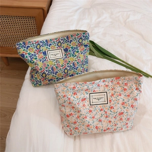 Detailed view of floral cotton canvas makeup bags with durable metal zippers and labels