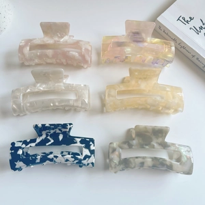 Top view of six rectangular acetate claw clips in assorted marble and floral patterns