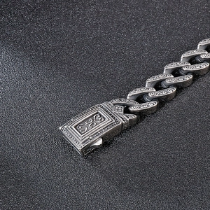 Detailed macro view of vintage engraved stainless steel bracelet with floral patterns
