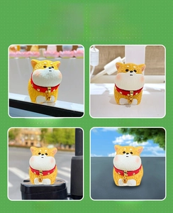 Detail of Shiba Inu resin dog ornament with red collar and bell for desk decor