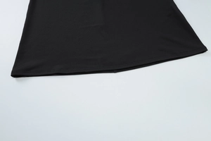 Detailed view of the double-stitched hem on a black lace backless bodycon dress