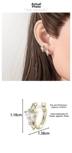 Detailed view of gold heart huggie earrings with cubic zirconia and size dimensions