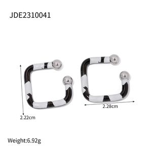Detail shot of zebra pattern square ear clips with silver ball ends and dimensions