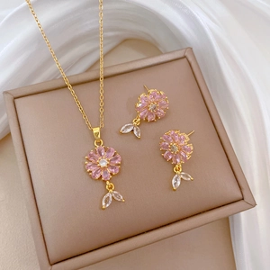 Elegant gold flower jewelry set with pink crystals and matching necklace and earrings