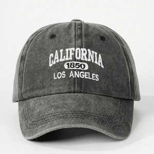 Close-up of white California embroidery on dark grey washed denim vintage baseball cap