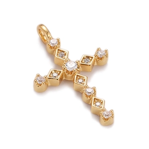 Macro shot of gold-plated hip hop cross pendant with sparkling clear cubic zirconia stones