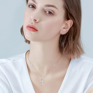 Classic moissanite cross pendant necklace in S925 sterling silver worn by a model