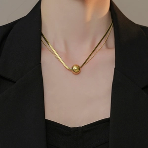 Elegant gold titanium steel double-layered necklace featuring a polished sphere pendant