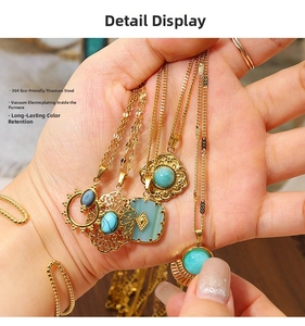 Detailed close-up of blue natural stone pendants with hollow engraved gold steel chains