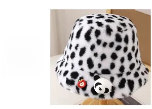 Detail of plush leopard print bucket hat featuring a cute panda and apple accent