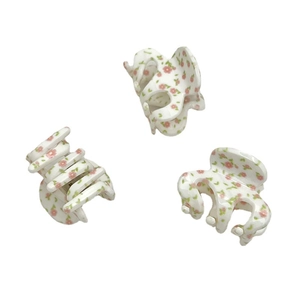 Three cute floral hair claws with pink flowers on white acrylic in a clean group shot