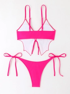Flat lay of pink two-piece bikini featuring butterfly-shaped hem and side-tie bottoms