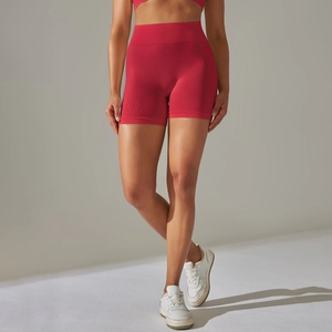 Detail of red high-waisted seamless shorts with ribbed waistband for yoga and fitness