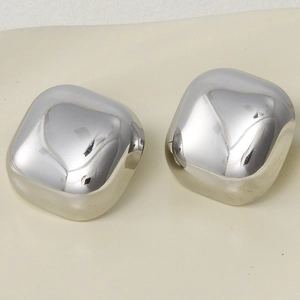 Close-up of square silver stainless steel stud earrings with rounded corners and metal shine