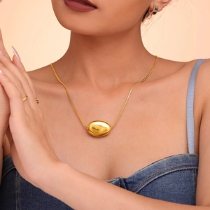 Minimalist double layered gold plated titanium steel necklace with oval pendant on model