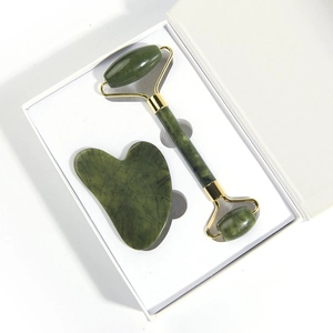 Natural green jade roller and heart-shaped gua sha set in a premium white gift box