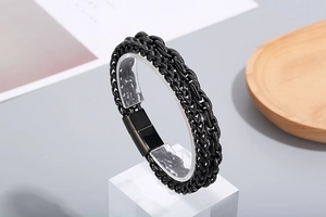 Detail of black double-layered metal chain bracelet with secure magnetic clasp design