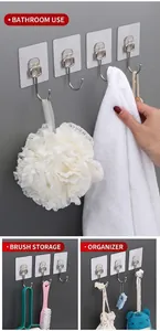 Detailed views of transparent adhesive wall hooks holding towels, brushes and bags