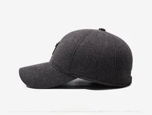 Detailed side view of dark grey baseball cap with textured twill and metal logo