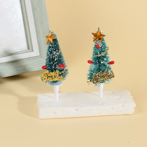 Mini green Christmas tree cake toppers with gold stars and Merry Christmas signs