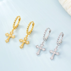 Detail of silver and gold cross hoop earrings with S925 hallmark and zircon stones
