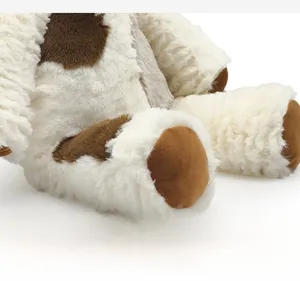 Detailed macro view of the plush teddy dog's soft beige fur and neat stitching quality