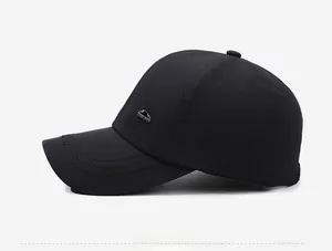 Detail of black baseball cap featuring breathable fabric and metallic mountain logo