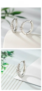Macro detail of silver star hoop earrings with micro-set zircon stones in natural lighting