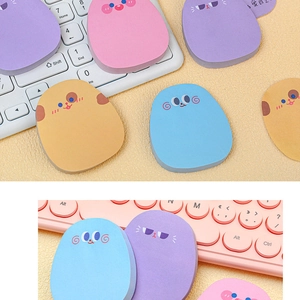 Detail showing colorful cartoon animal-shaped sticky notes on a laptop keyboard