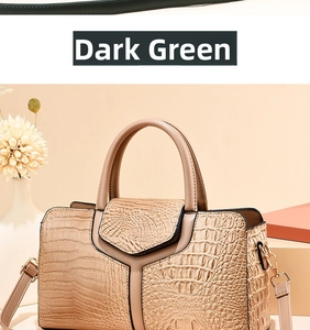 Detail of beige croc-embossed boston handbag showing fine texture and metal D-ring hardware