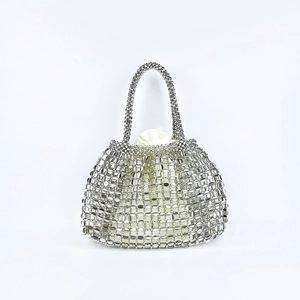 Detail of silver metallic woven handbag featuring sequins and a cream drawstring lining