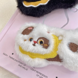 Detail of plush lion dance and lucky cat eye masks with traditional Chinese embroidery