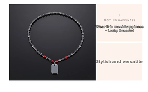 Detailed view of hematite beaded necklace with red accents and a rectangular steel pendant