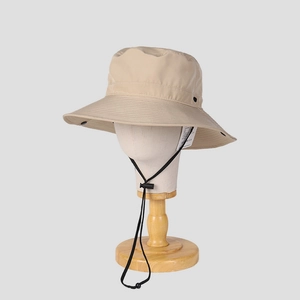 Detail of a beige wide brim sun hat featuring quick-dry fabric and adjustable chin strap