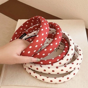 Retro red and white polka dot padded headbands stacked for a high crown voluminous look