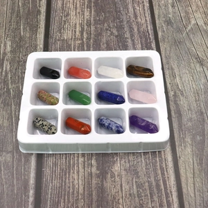 Detailed set of 12 natural crystal hexagonal prisms in a white plastic display tray