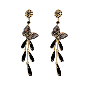 Elegant black butterfly earrings with long fringe tassels and teardrop gems on white background