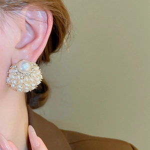 Detail of floral faux pearl cluster earrings with micro crystal accents on gold base