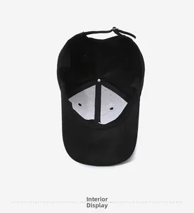 Interior view of black embroidered baseball cap showing stitching and adjustable strap