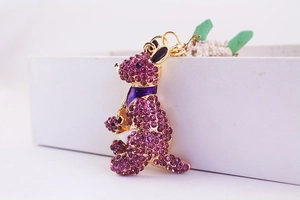 Detail of purple rhinestone kangaroo keychain with golden metal base in a white gift box