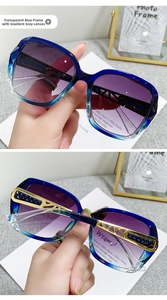 Detail of blue gradient oversized sunglasses with intricate gold metal temple patterns