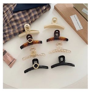 French style hair claw clips set in amber and cream showing geometric circle details