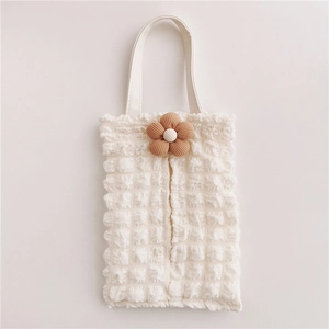Detail of cream bubble textured car tissue box holder with brown knitted flower charm