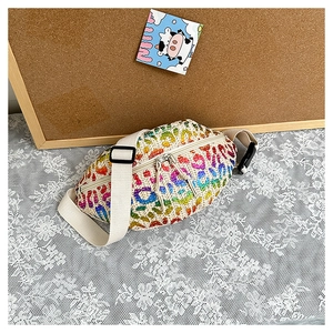 Detail of rainbow leopard print woven waist bag with dual zippers and adjustable strap