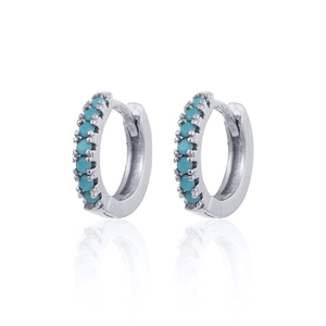 Macro detail of silver S925 earrings with turquoise cubic zirconia on white base