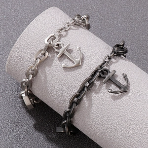 Detailed close-up of navy style anchor pendants on chunky steel chains for men